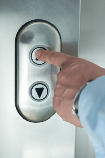 Image of elevator button being pressed